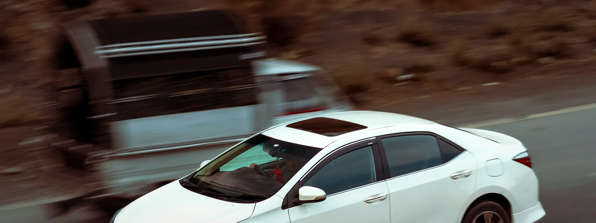 A white car on a mountain road near Kohat