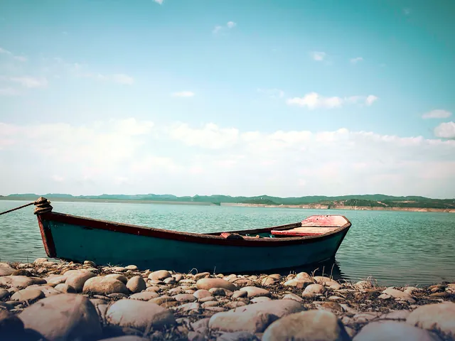 A wooden boat moored on the calm lake at New Mirpur City