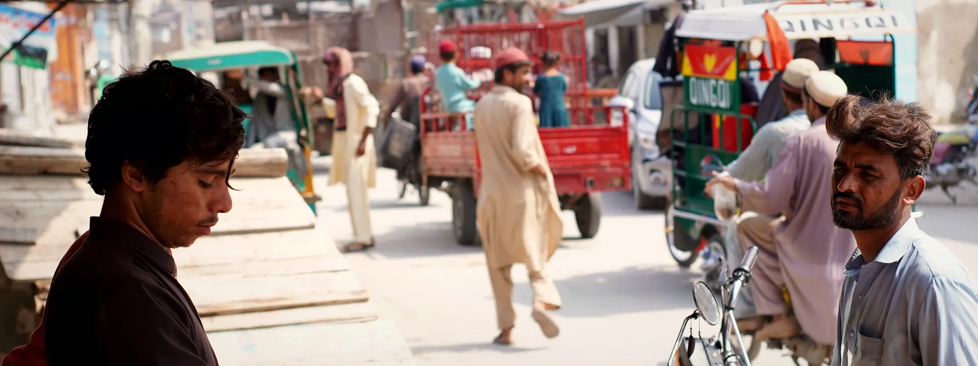 A street food vendor at work on a busy street in Nowshera