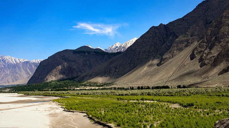 Mountains rising above a lush green valley in Azad Jammu and Kashmir