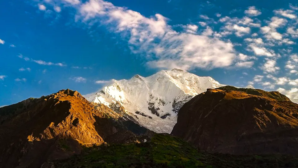 Snow-capped Rakaposhi peak under a clear blue sky in Gilgit-Baltistan