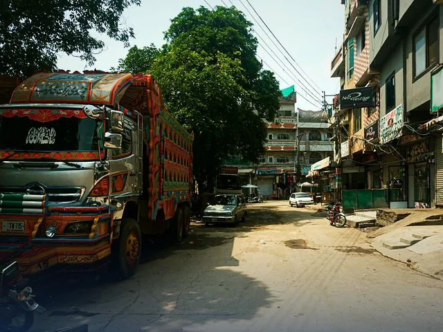 A brightly decorated truck parked on a busy street in Rawalpindi