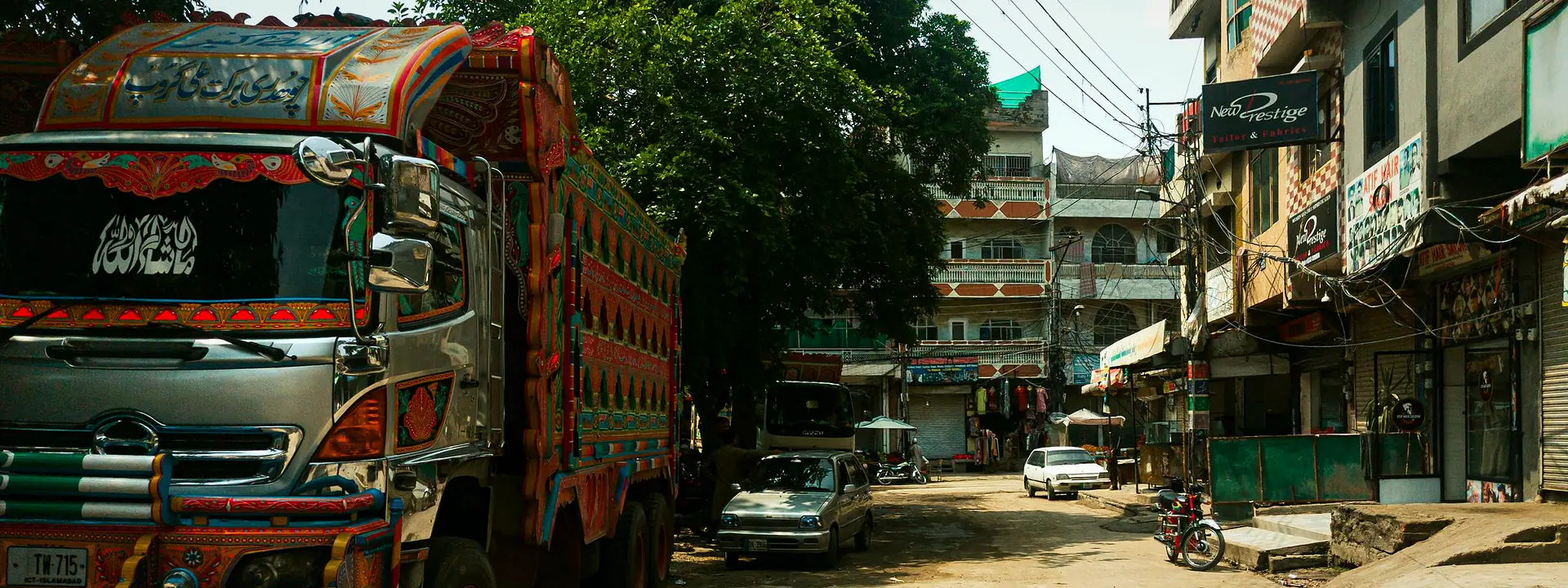 A brightly decorated truck parked on a busy street in Rawalpindi